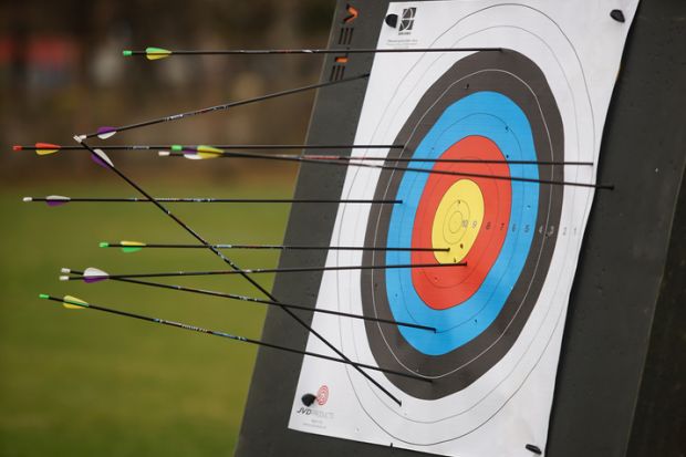 An archery target full of arrows